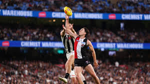 AFL is reviewing Opening Round amid the code clash with the Anniversary Test match | Hird rips Op…