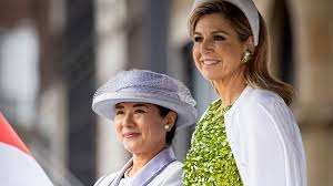 Queen Máxima shines in bold green dress with floral appliqués while Empress Masako opts for sil…